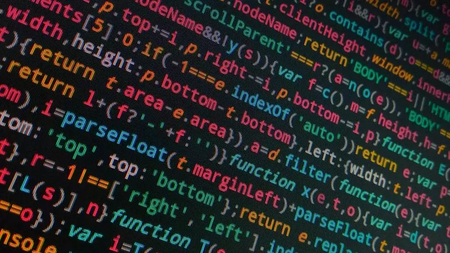 Tilted photo of coding text on a black screen