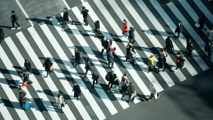 Different people crossing a road