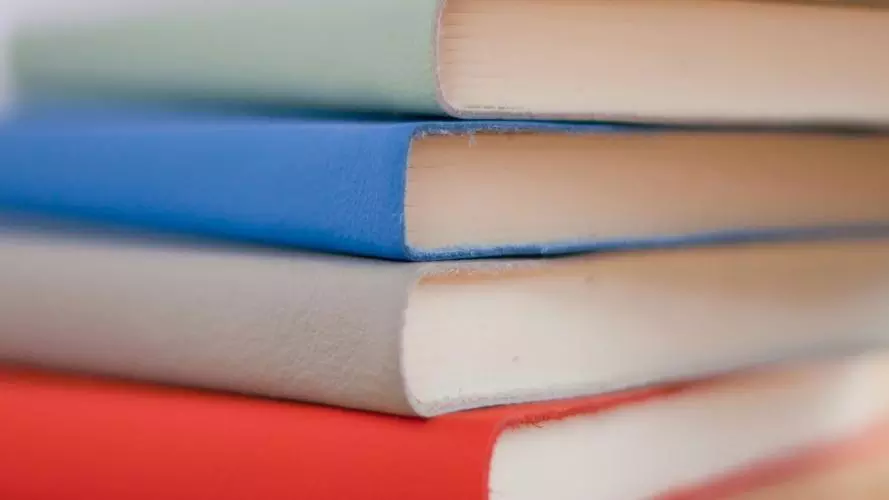 Photo of a stack of three diaries, each in different colour