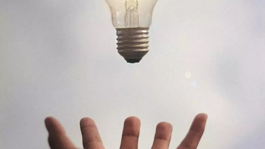 Person catching light bulb