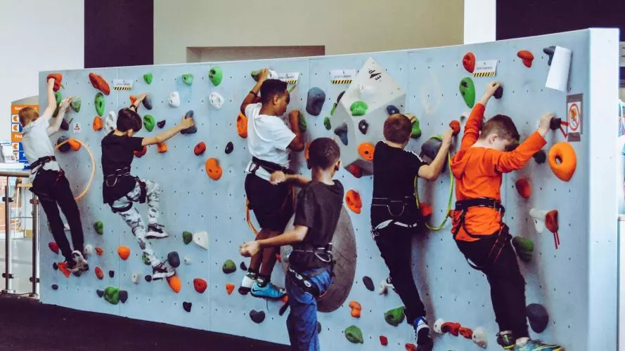 6 kids on a climbing wall