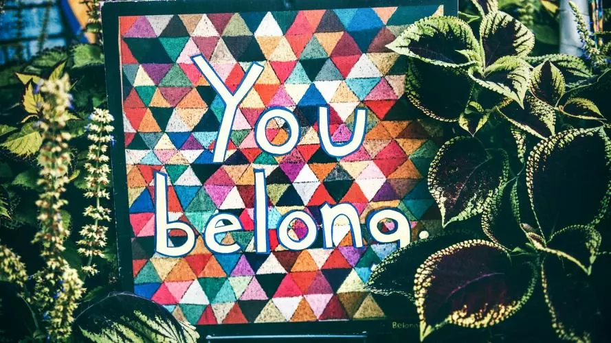 Mural painting with writing "You Belong" surrounded  by plants.
