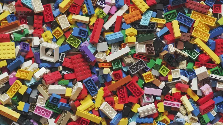 Photo of a pile of lego blocks of many different colours, shapes, and sizes.