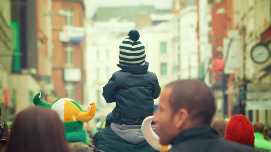 Child on shoulders in crowd
