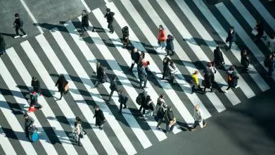 Different people crossing a road