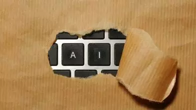 A piece of cardboard with a keyboard showing AI appearing