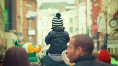 Child on shoulders in crowd