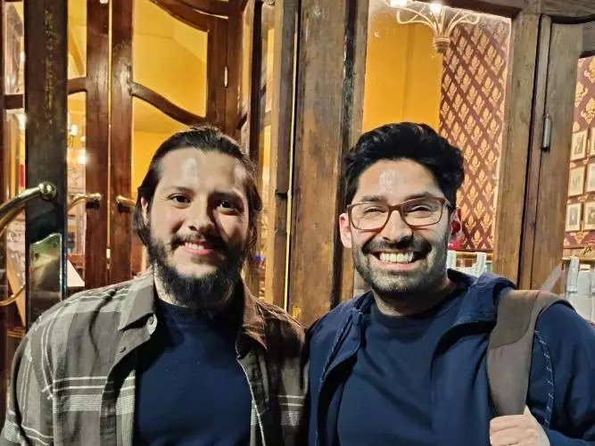 Two men smiling to the camera