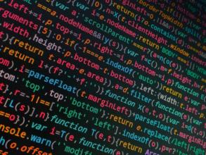 Tilted photo of coding text on a black screen