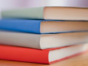 Photo of a stack of three diaries, each in different colour