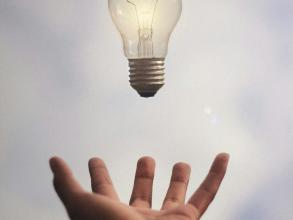 Person catching light bulb