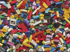 Photo of a pile of lego blocks of many different colours, shapes, and sizes.