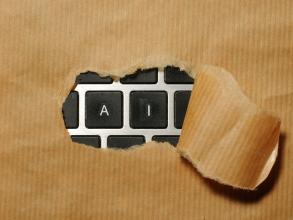 A piece of cardboard with a keyboard showing AI appearing