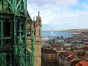 Aerial view of Geneva with St Pierre's Cathedral in the front and the sea in the back.